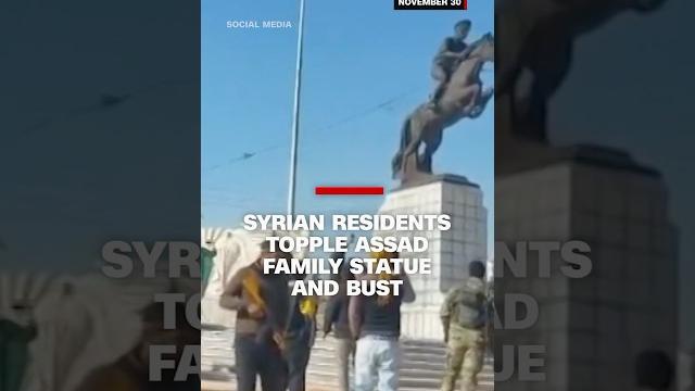Syrian residents topple Assad family statue and bust Syrian residents topple Assad family statue and bust